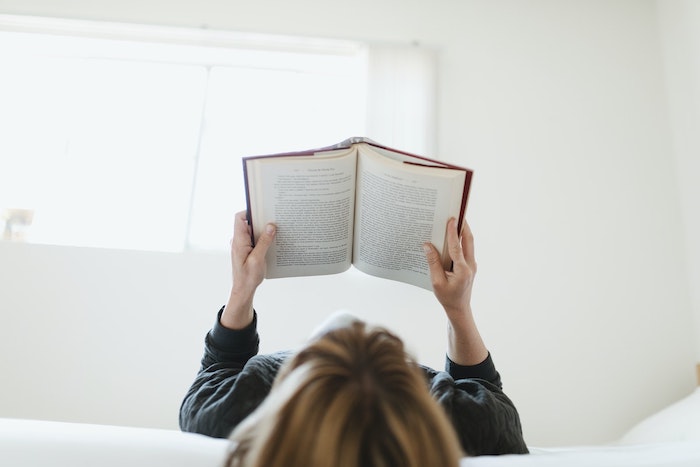 A woman is reading a book as part of her narrative therapy.