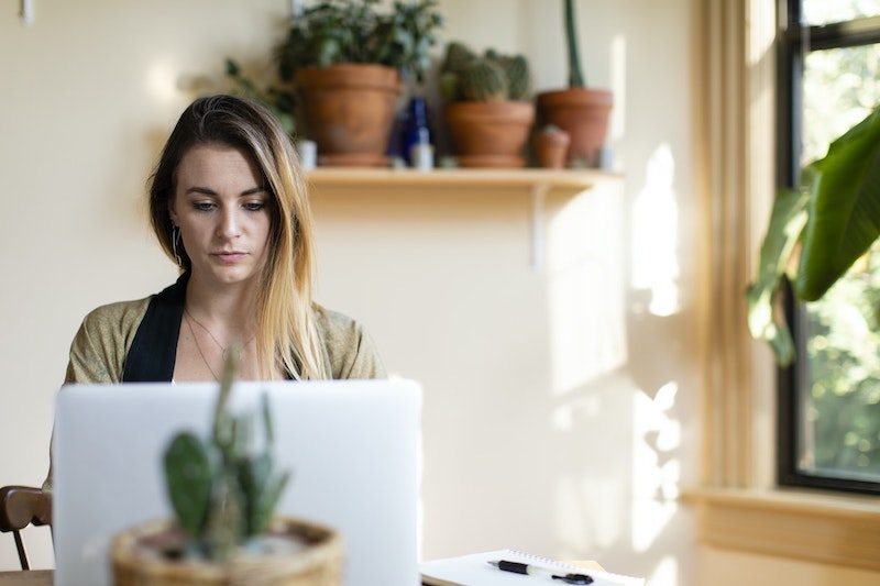 A woman sits at her laptop, reading her OCD test results and learning how to move forward.