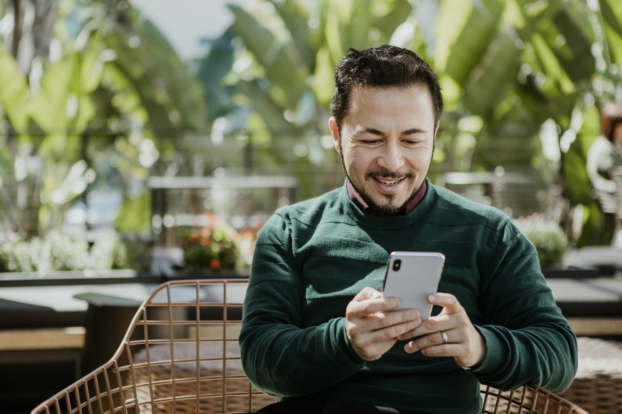 man smiling at his phone