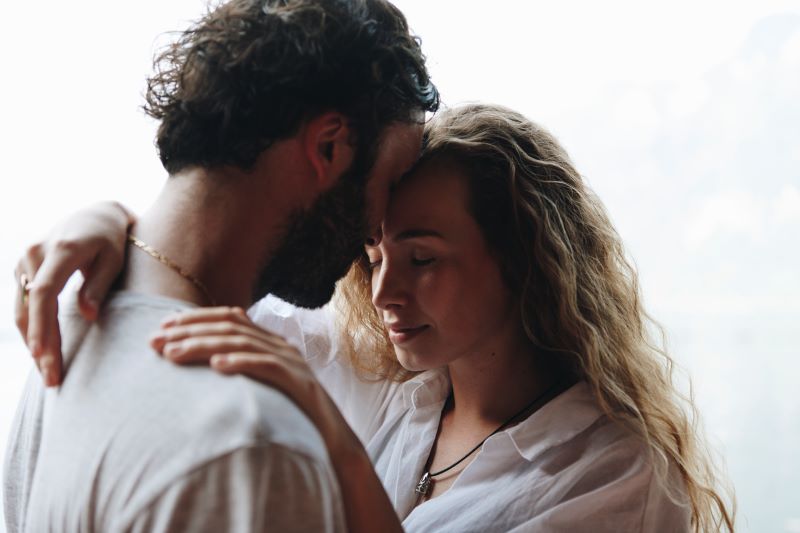 Am I in love with my best friend? Learn the difference between platonic and romantic love. This couple hugs romantically with their foreheads connected, wondering if their friendship has turned into something more.